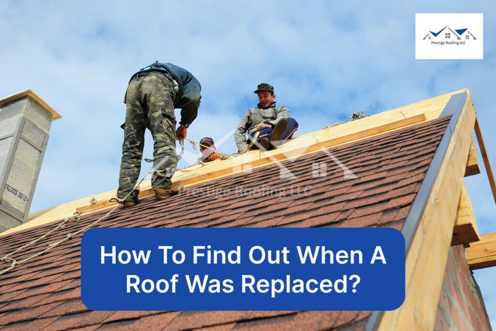 Roofing contractors working on a house roof replacement under blue sky.