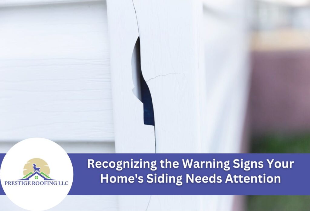 Damaged white house siding with visible crack and gap showing warning signs needing repair