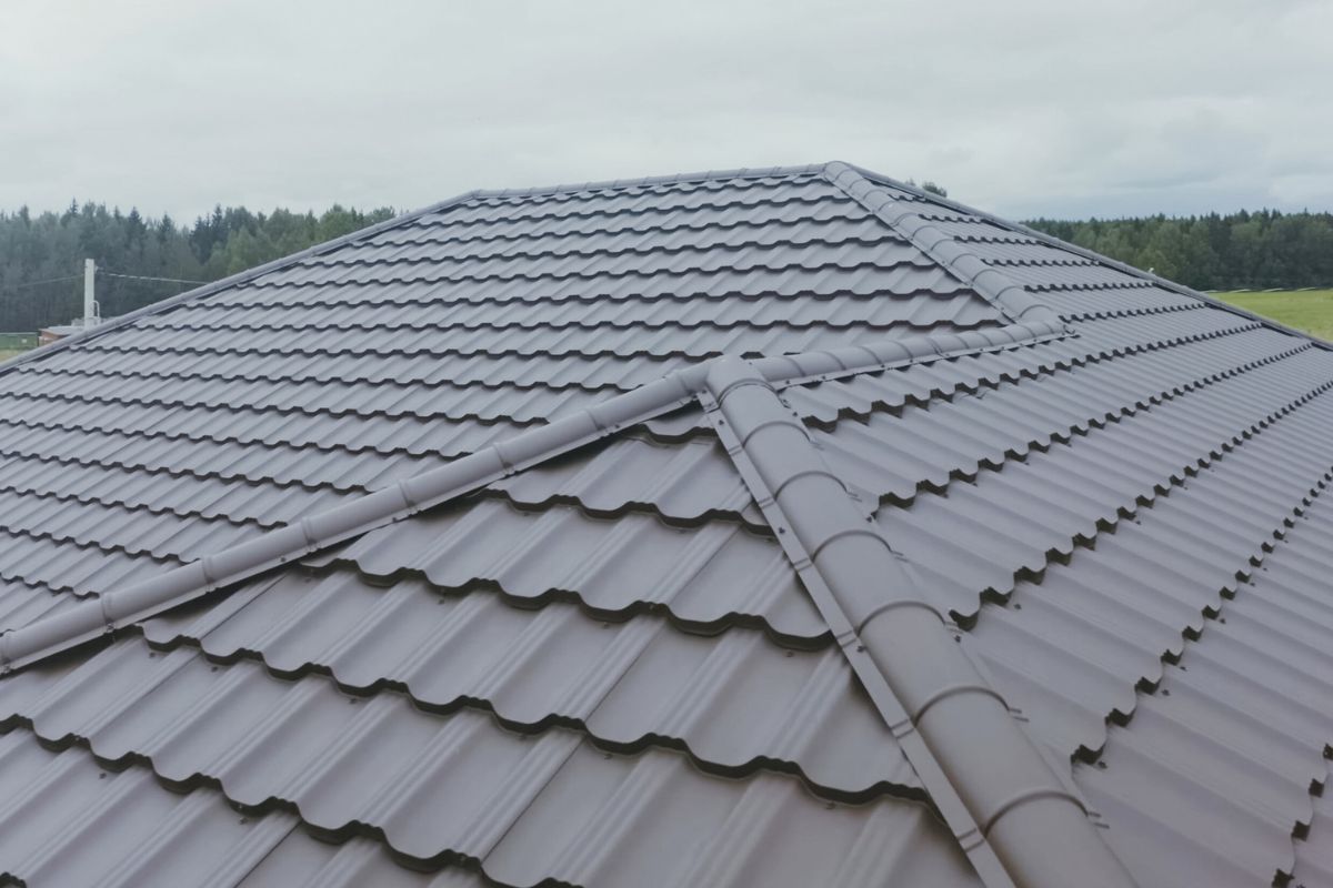 Gray metal tile roof with paneled design in a rural setting