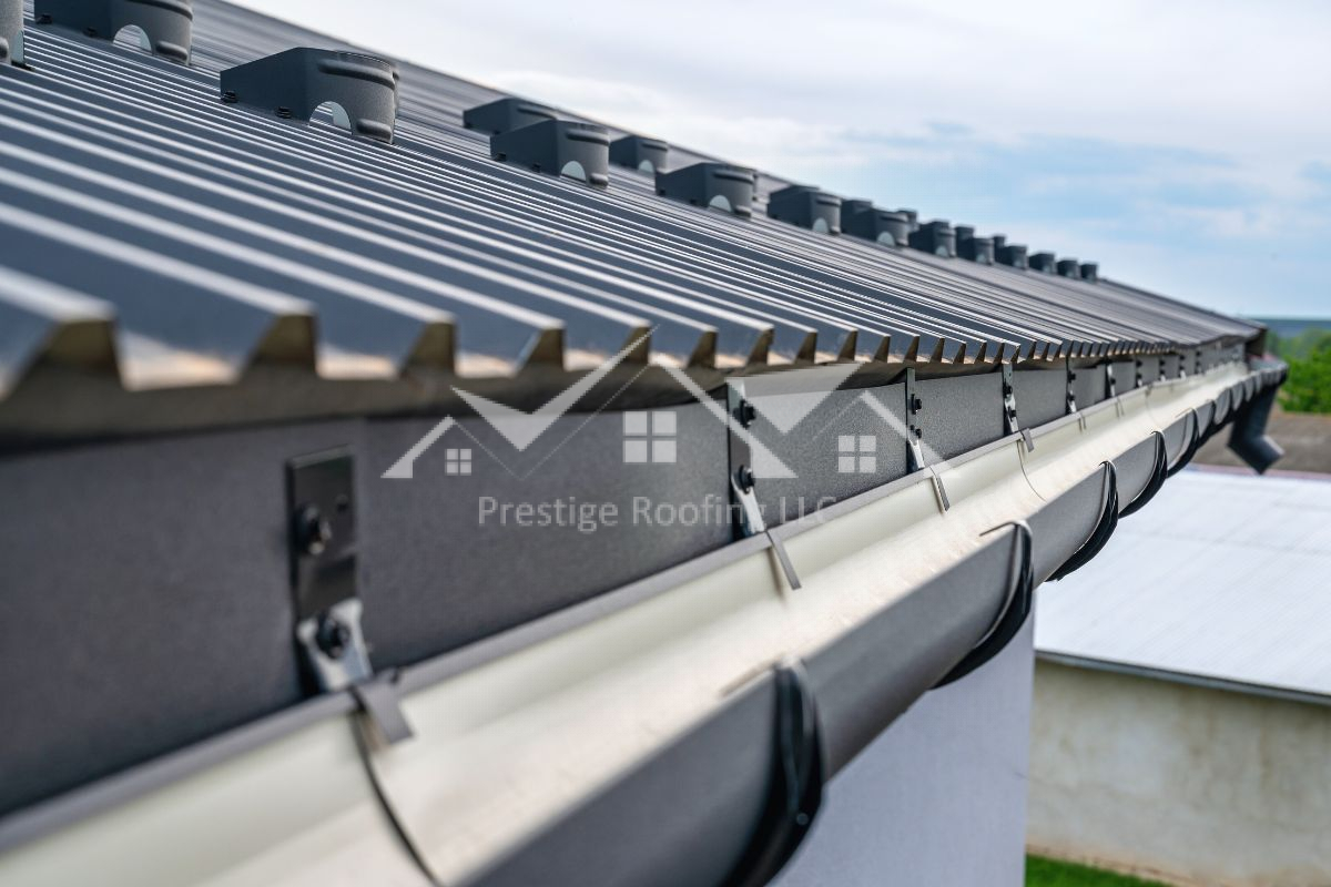 Close-up view of metal roof panels with attached gutter system.