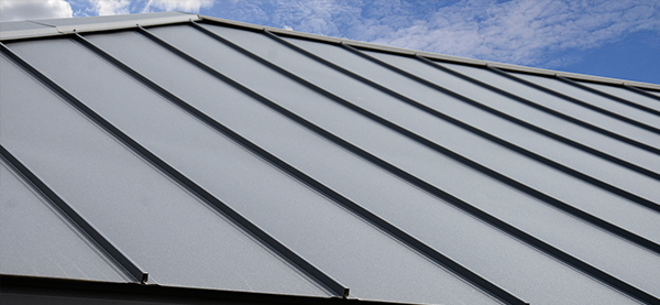 Modern metal roof with standing seam design under blue sky