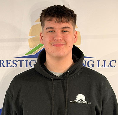 Young man in a black hoodie with Prestige Roofing LLC logo.